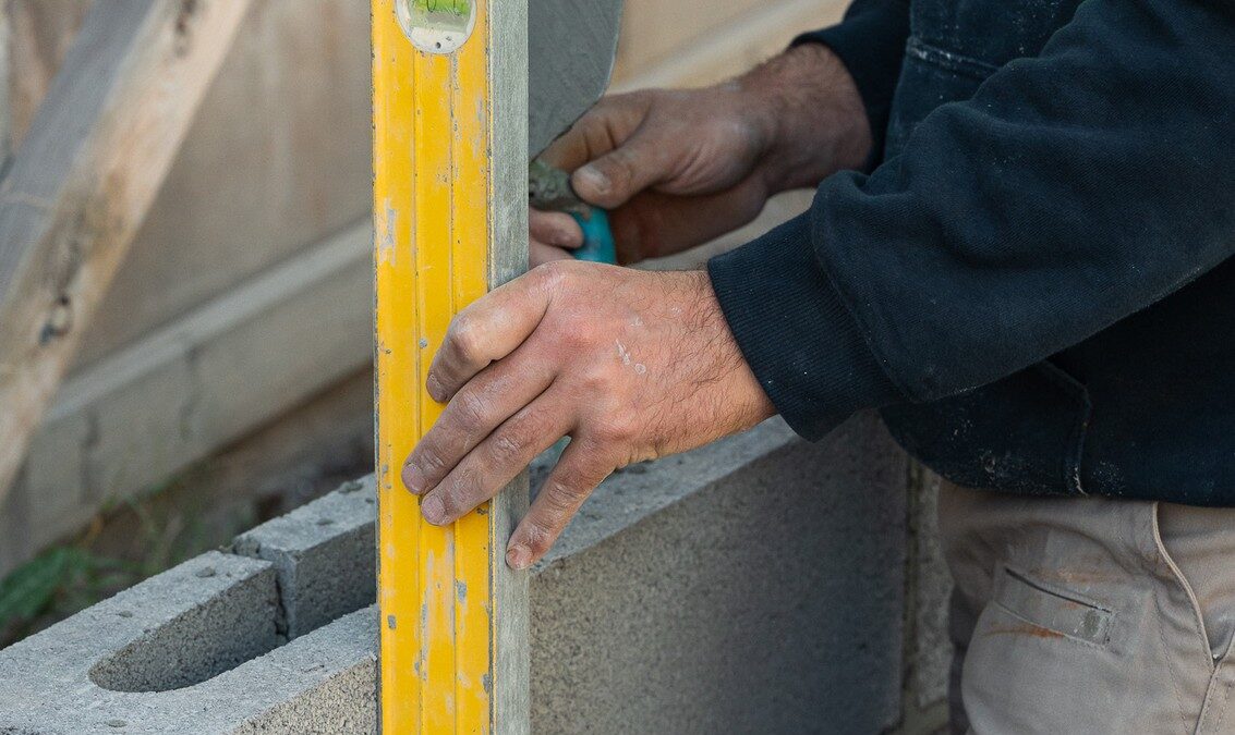 Block wall being levelled for a Sunshine Coast retaining wall